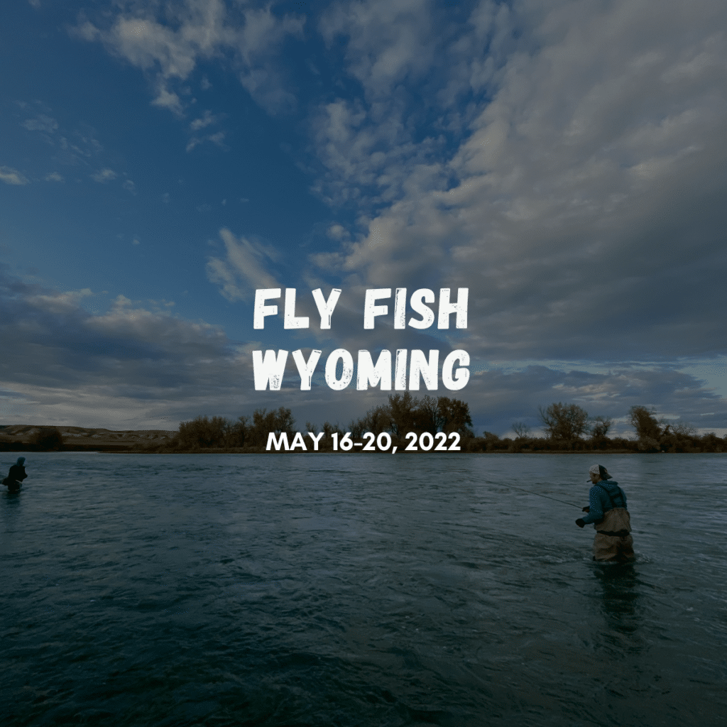 men fly fishing in a river